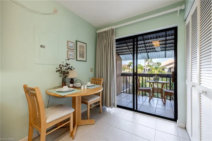 Tiled dining room featuring electric panel