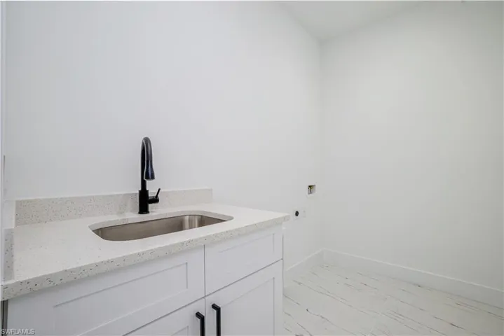 Bathroom with marble finish floors and vanity