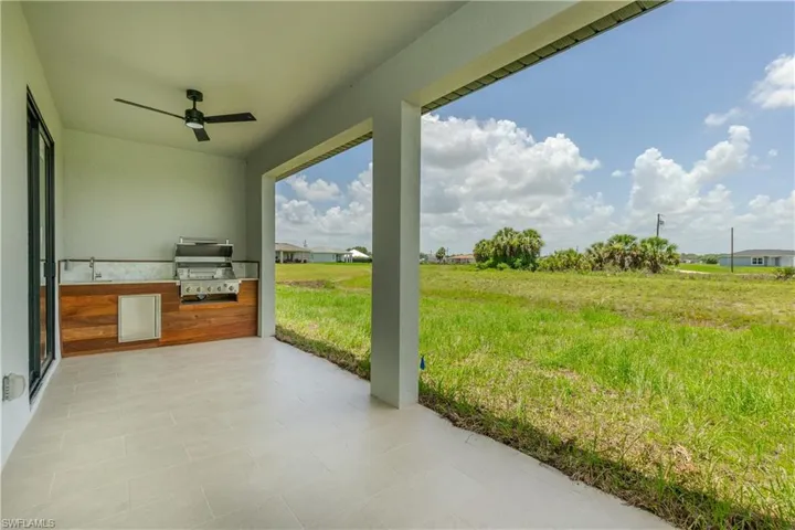 View of patio / terrace featuring an outdoor kitchen and ceiling fan