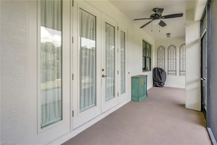 Unfurnished sunroom with ceiling fan