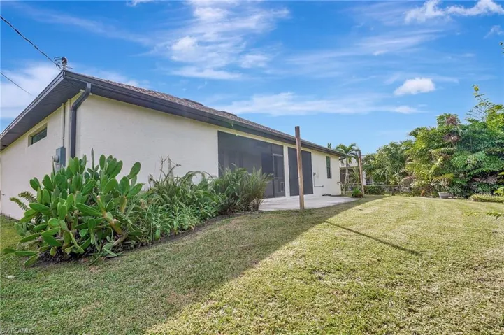 View of home's exterior and large backyard