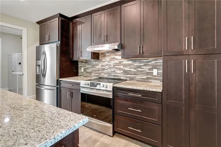 Kitchen featuring light stone countertops, appliances with stainless steel finishes and Tons of Storage.