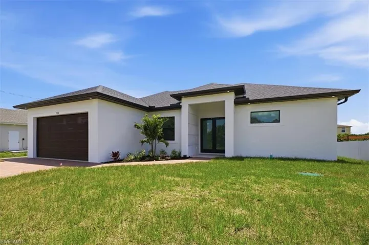 Single-story residence featuring a white stucco exterior, dark shingle roof, and an attached two-car garage with a brown door
