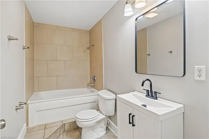 Clean and functional full bath conveniently located for guests and secondary bedrooms.