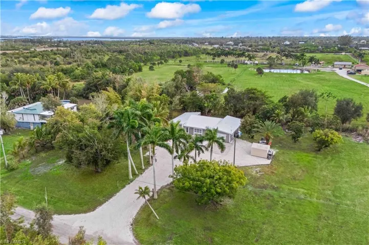 Tucked away on over an acre, this gated Pine Island retreat offers peace, privacy, and space to breathe.