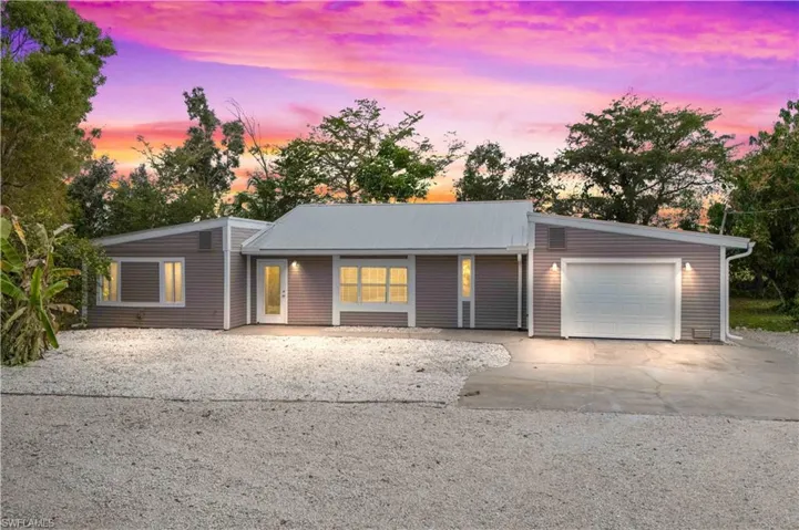 Welcome home to your private Pine Island retreat—nestled on over an acre of lush, peaceful land with a gated front yard and serene island surroundings.
