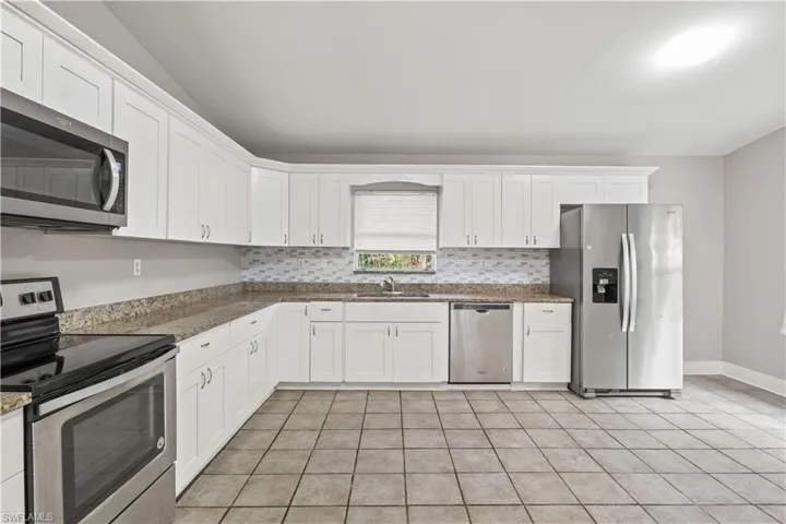 A chef-friendly kitchen with generous counter space and seamless flow to the family area.