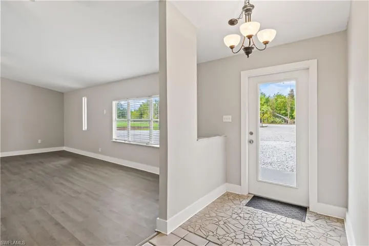 Spacious indoor entrance with natural light streaming through large windows.