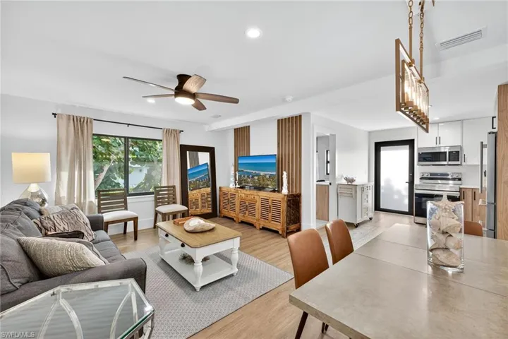 Living room featuring a ceiling fan, light wood finished floors, and recessed lighting
