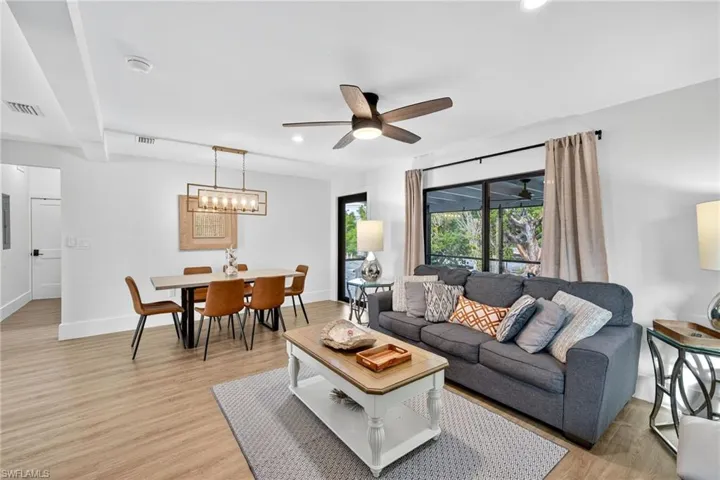 Living area featuring light wood-style flooring, recessed lighting, and ceiling fan