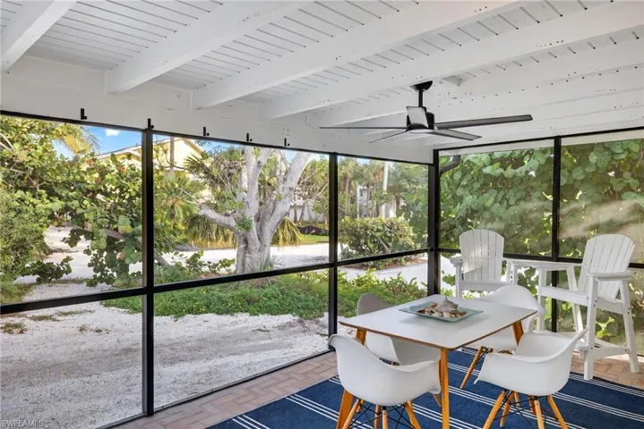 Sunroom with a ceiling fan and a fire pit