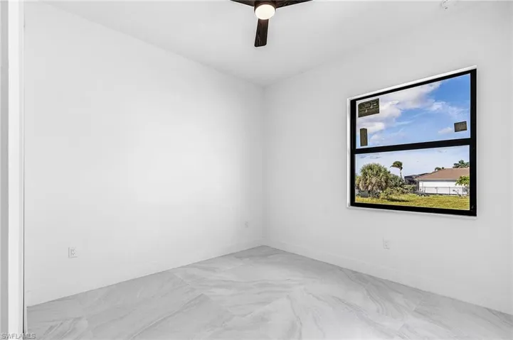 Unfurnished room with baseboards and a ceiling fan