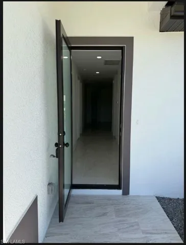 Entrance to property featuring stucco siding