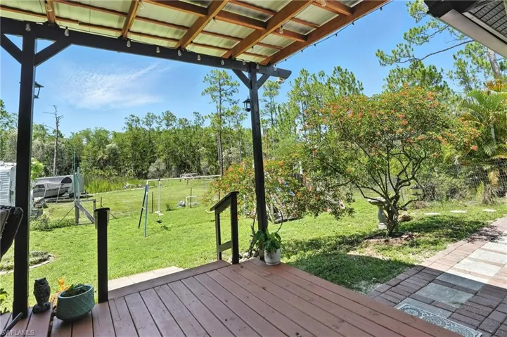 Deck featuring view of scattered trees
