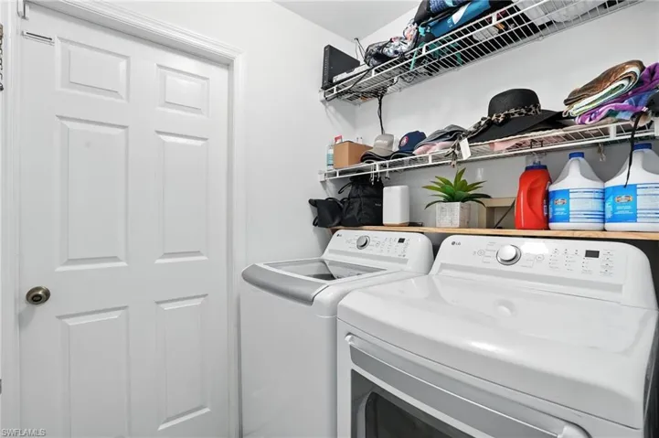 Washroom with washing machine and clothes dryer