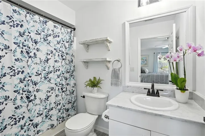 Full bath featuring vanity, ensuite bathroom, and a shower with shower curtain