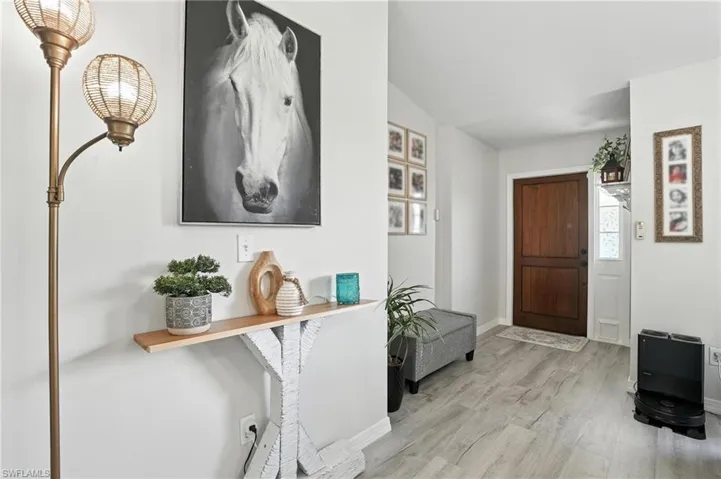 Foyer entrance featuring wood finished floors and baseboards