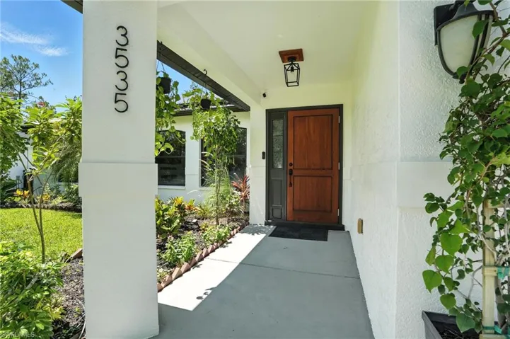Entrance to property with stucco siding