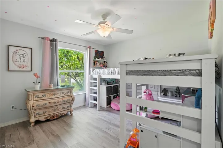 Bedroom featuring light wood-type flooring and ceiling fan