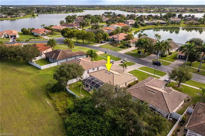 Aerial perspective of suburban area featuring a nearby body of water