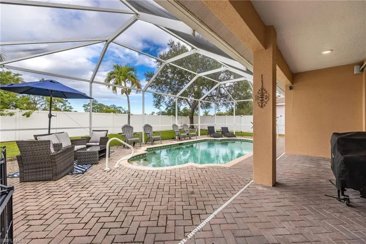 View of swimming pool featuring a patio area, a lanai, a sunroom, and a fenced backyard