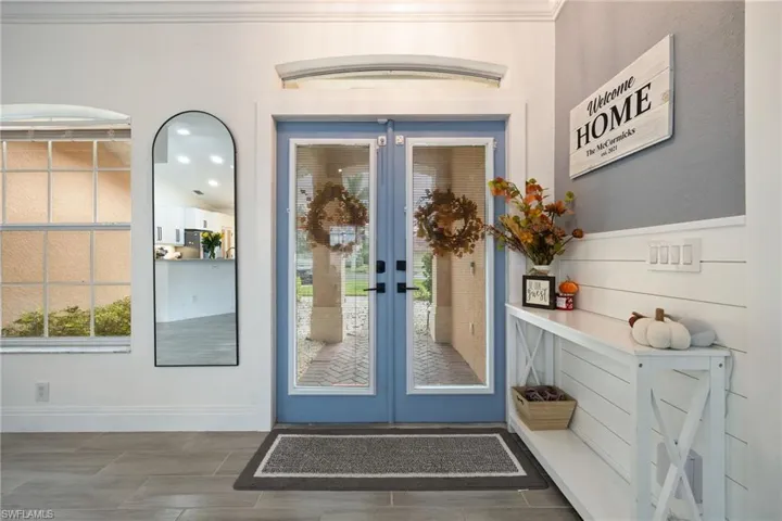 Doorway to outside featuring french doors, plenty of natural light, and wood finish floors