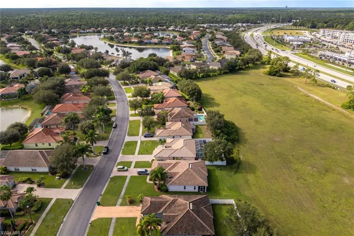 Aerial overview of property's location featuring nearby suburban area and a large body of water