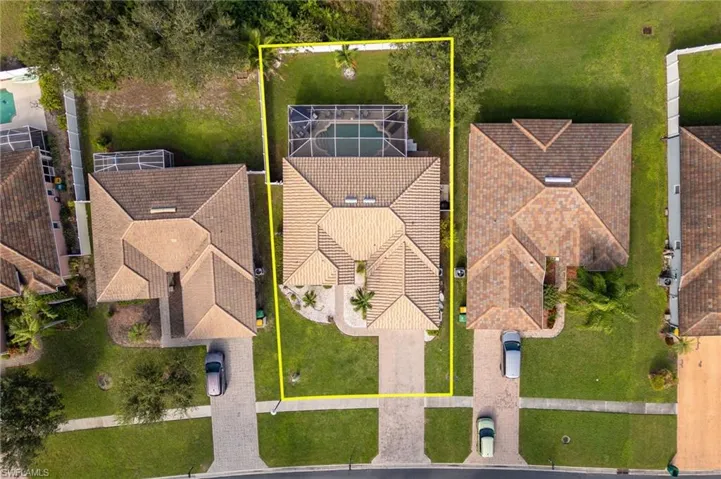 Aerial perspective of suburban area featuring property boundaries highlighted