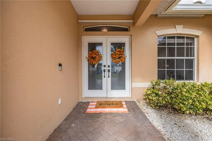 Entrance to property featuring french doors and stucco siding