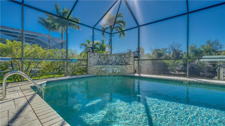 Swimming pool featuring a waterfall