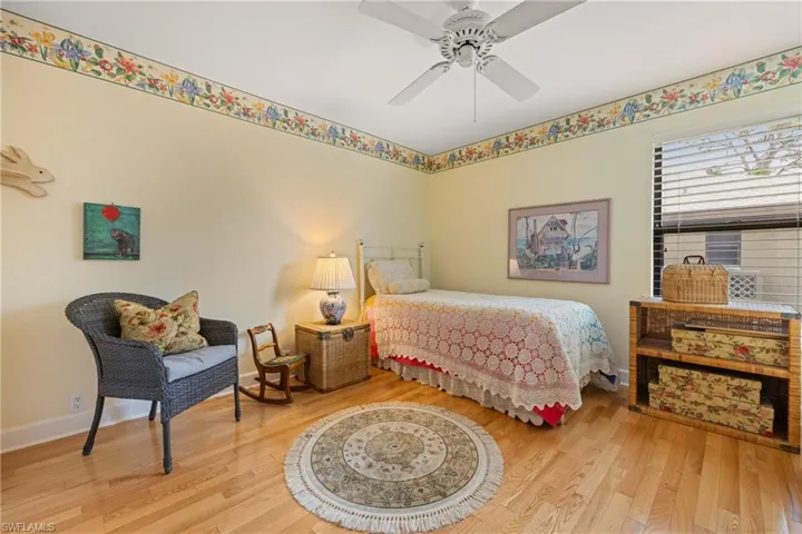 Bedroom featuring hardwood / wood-style flooring and ceiling fan