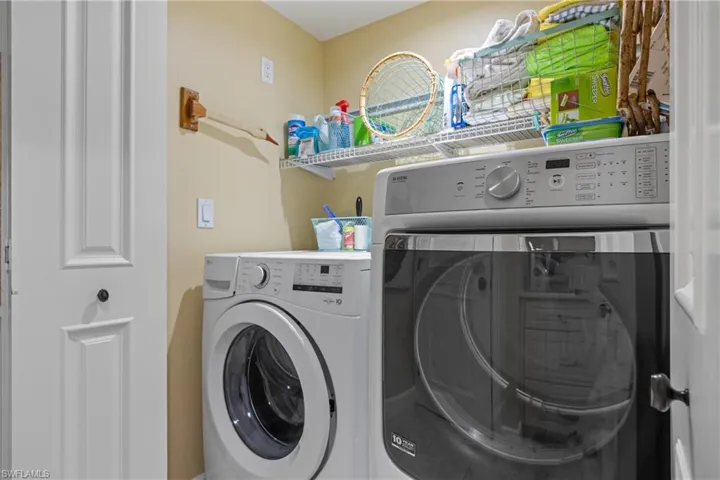 Clothes washing area featuring separate washer and dryer