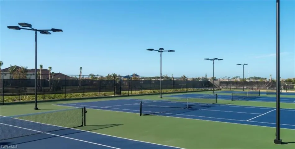 View of tennis court featuring community basketball court