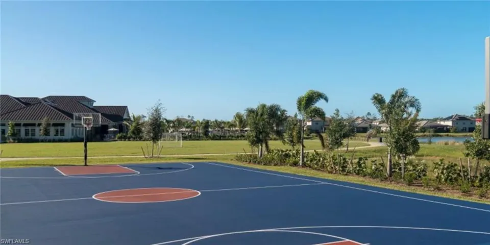 View of basketball court with community basketball court and a yard