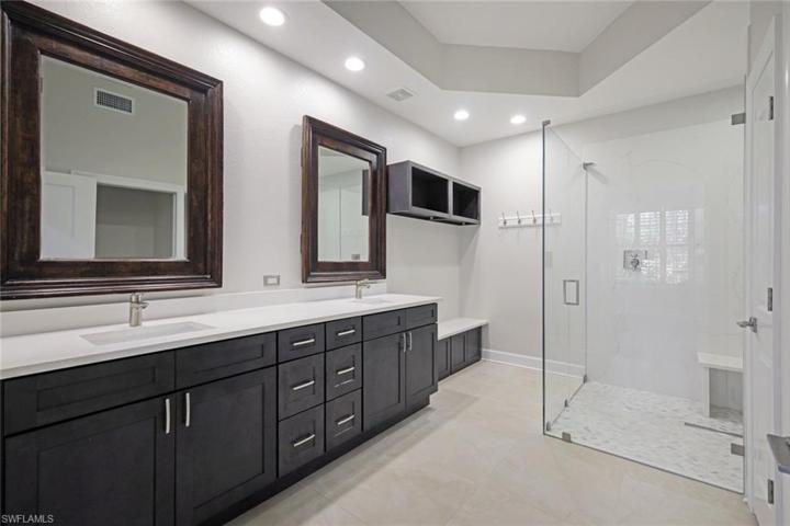 Fully custom bath with expanded seamless glass shower.