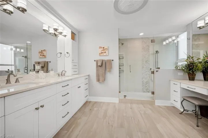 Bathroom with vanity, hardwood / wood-style floors, and walk in shower