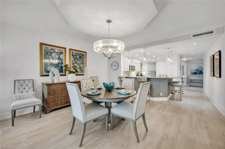 Dining space featuring a notable chandelier and light hardwood / wood-style floors