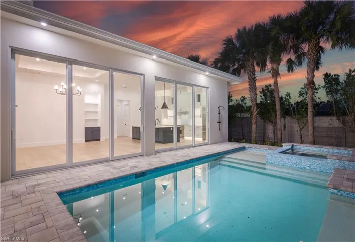 View of pool with a patio area and a pool with connected hot tub