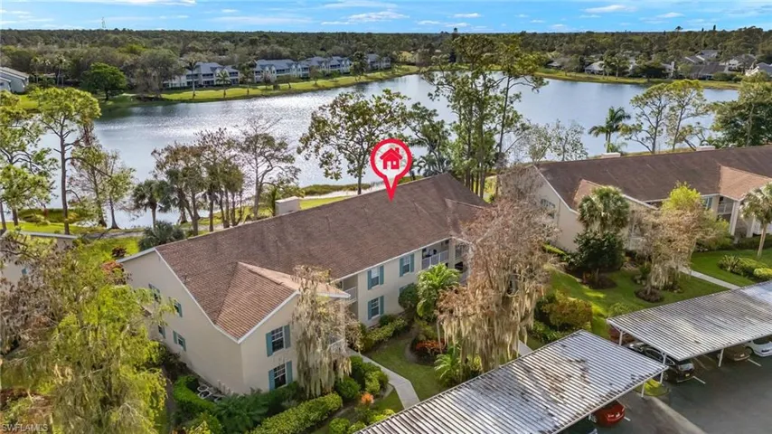 Birds eye view of property with a water view