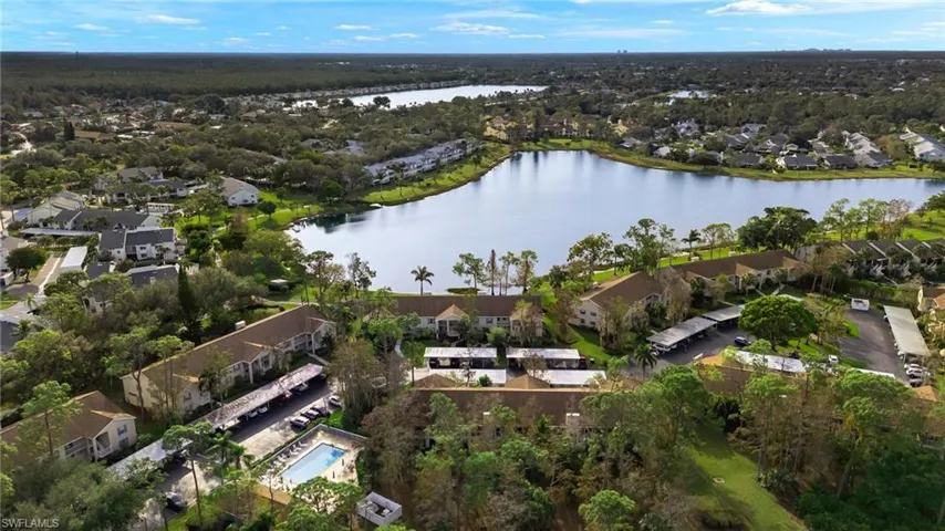 Birds eye view of property with a water view