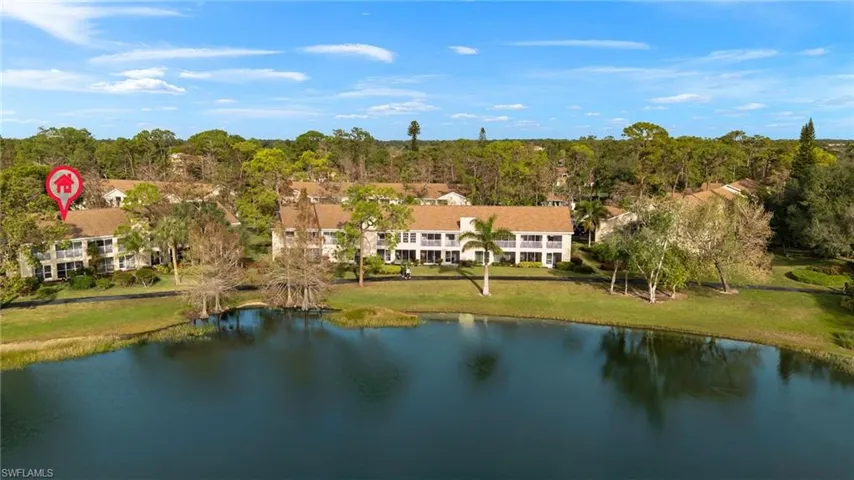 Birds eye view of property with a water view