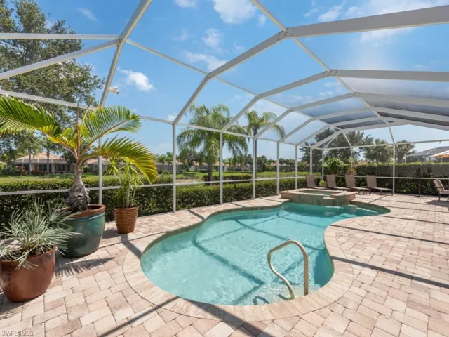 View of pool with a patio, a lanai, and an in ground hot tub