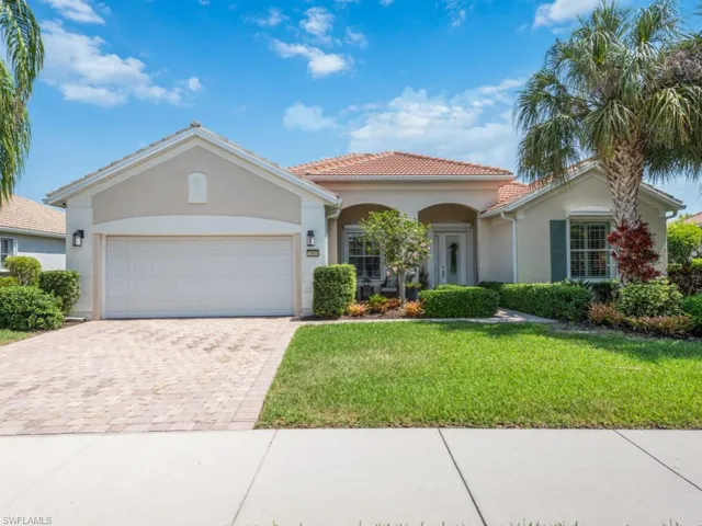 View of front of home featuring a garage and a front lawn