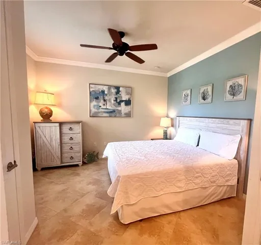 Bedroom featuring ceiling fan and crown molding