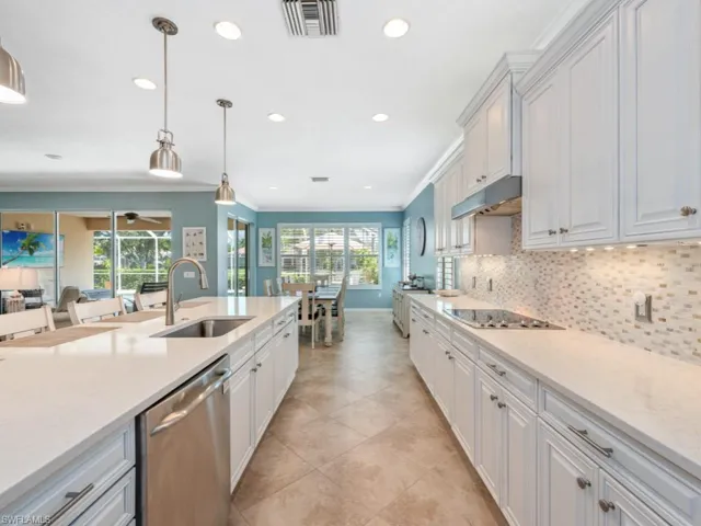 Kitchen with black electric stovetop, sink, plenty of natural light, and dishwasher