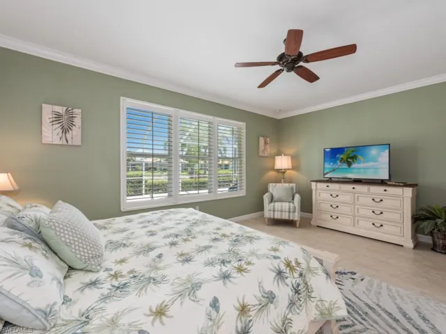 Bedroom with crown molding and ceiling fan
