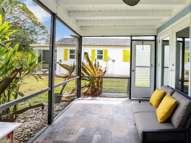 Unfurnished sunroom featuring french doors and beam ceiling