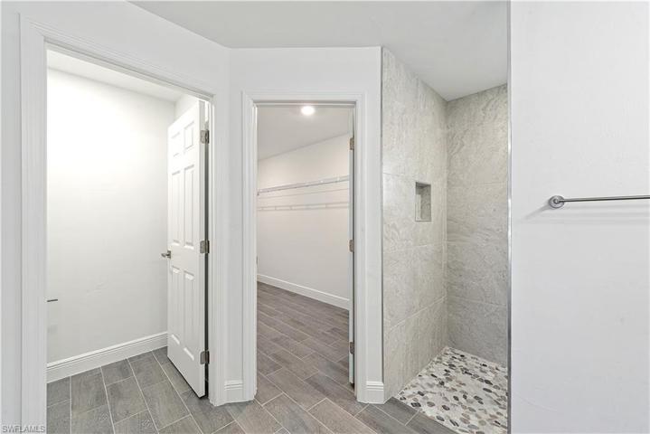 The Tiled Walk-In Shower Has A Pebble Stone Flooring!