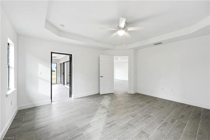 The Spacious Master Bedroom Has Trey Ceilings With A Light/Fan And A Private Entry Door Onto The Screened And Covered Lanai!