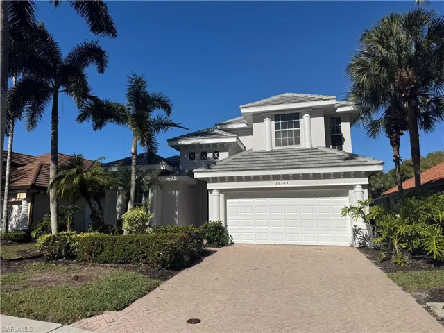 View of front of property featuring stucco siding, decorative driveway, a tiled roof, and a garage